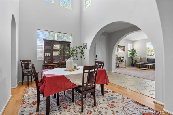 a dining room with furniture and wooden floor