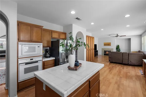 a kitchen with stainless steel appliances a sink a microwave a refrigerator and cabinets