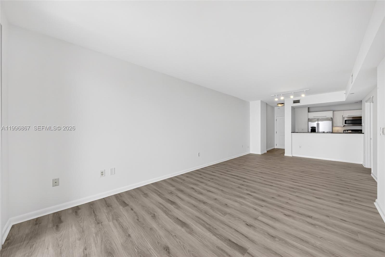 7350 Southwest 89th Street, Unit 1703S Miami, FL 33156 - Photo 11 of 29 a view of a kitchen with wooden floor and a sink