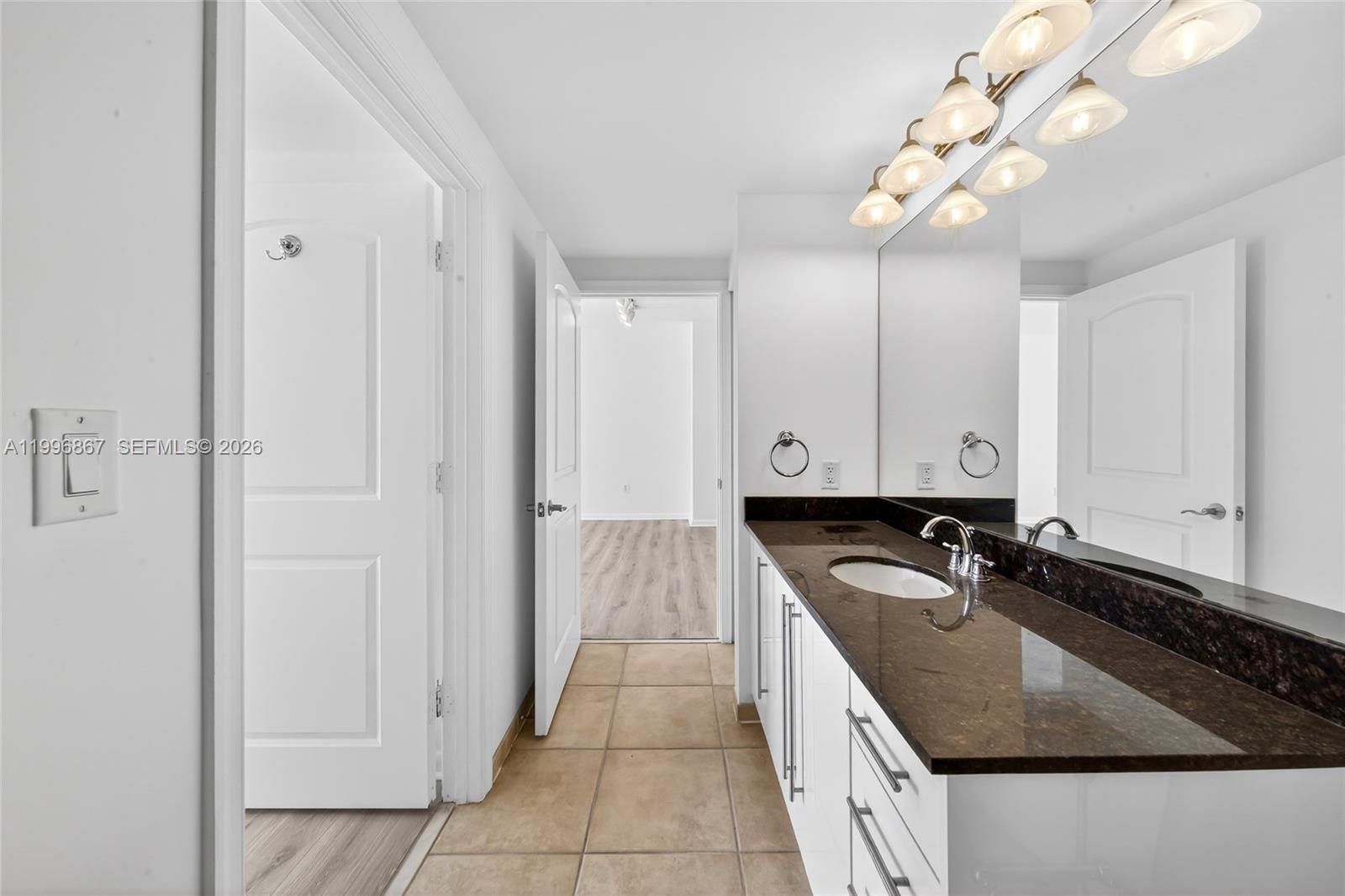 7350 Southwest 89th Street, Unit 1703S Miami, FL 33156 - Photo 15 of 29 a kitchen with granite countertop a sink a counter top space and cabinets