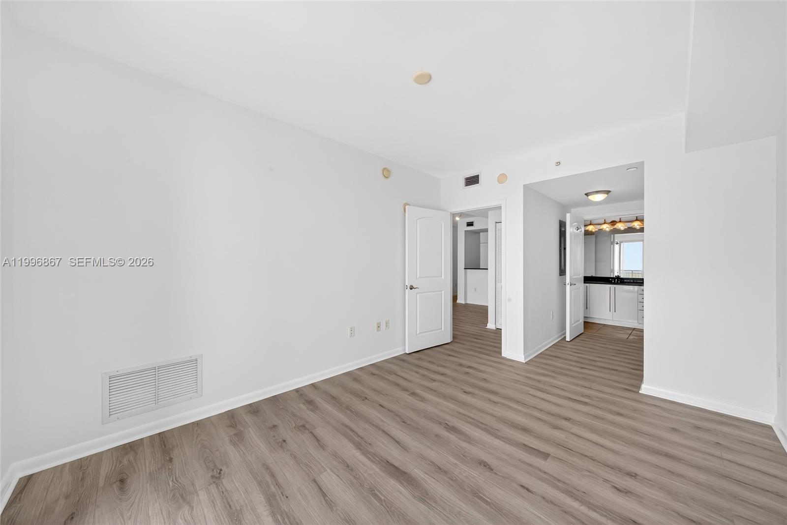 7350 Southwest 89th Street, Unit 1703S Miami, FL 33156 - Photo 19 of 29 a view of an empty room with wooden floor
