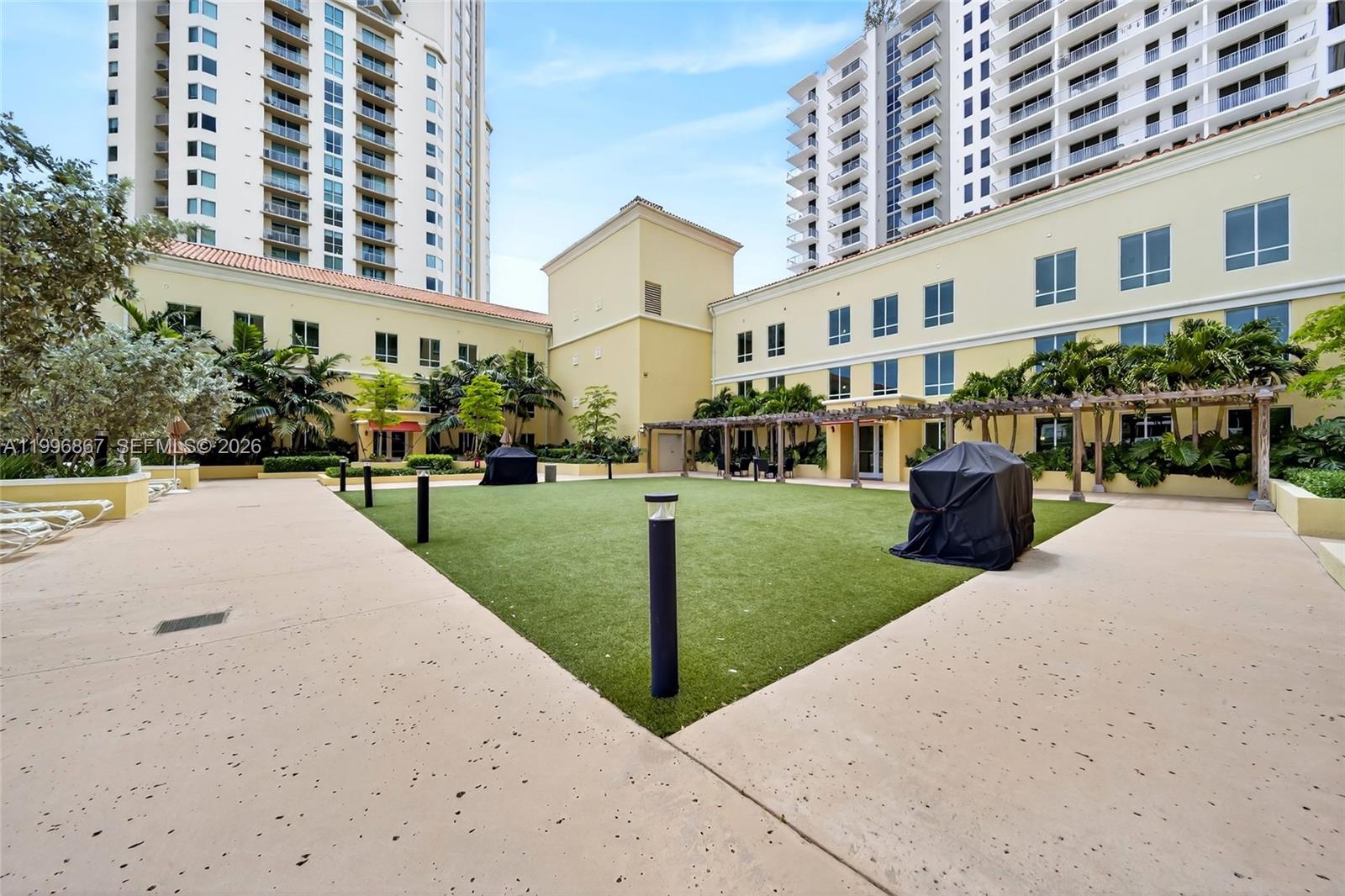 7350 Southwest 89th Street, Unit 1703S Miami, FL 33156 - Photo 25 of 29 a front view of a building with a yard