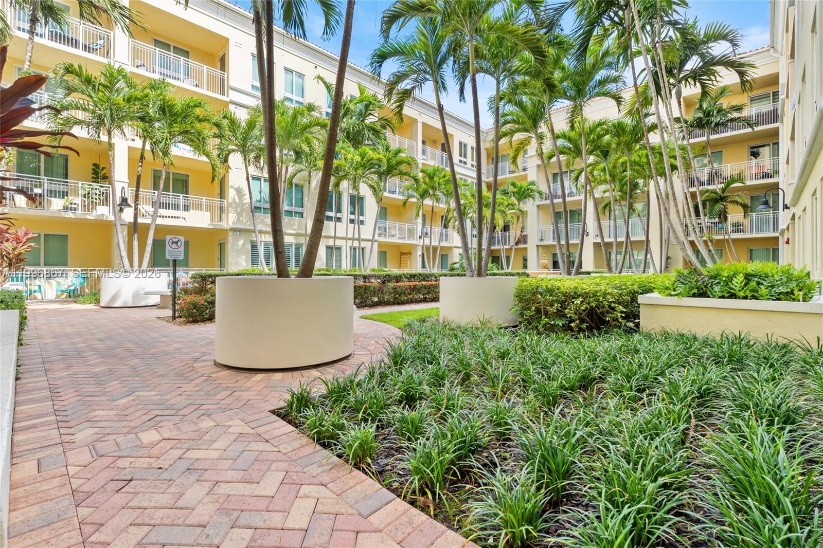 7350 Southwest 89th Street, Unit 1703S Miami, FL 33156 - Photo 29 of 29 a view of a building with a garden and trees