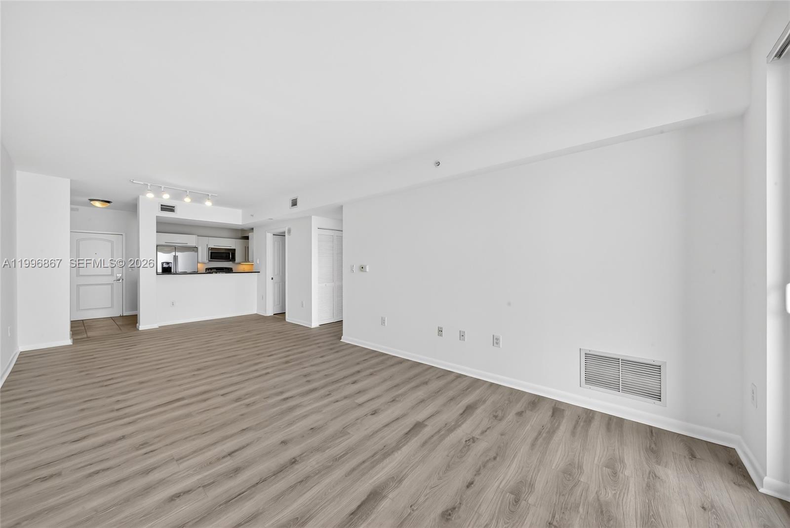 7350 Southwest 89th Street, Unit 1703S Miami, FL 33156 - Photo 10 of 29 a view of empty room with wooden floor