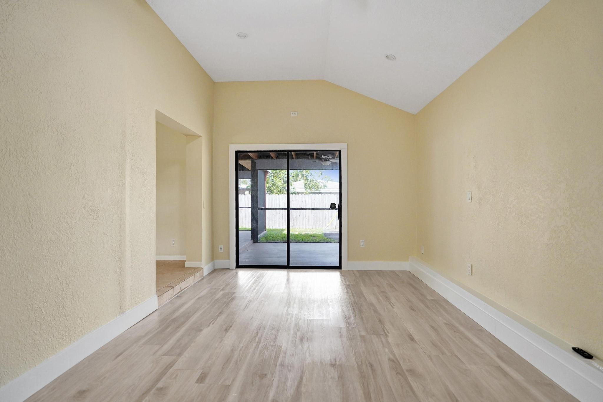 5425 Cleveland Road Delray Beach, FL 33484 - Photo 18 of 39 a view of an empty room with wooden floor and a window