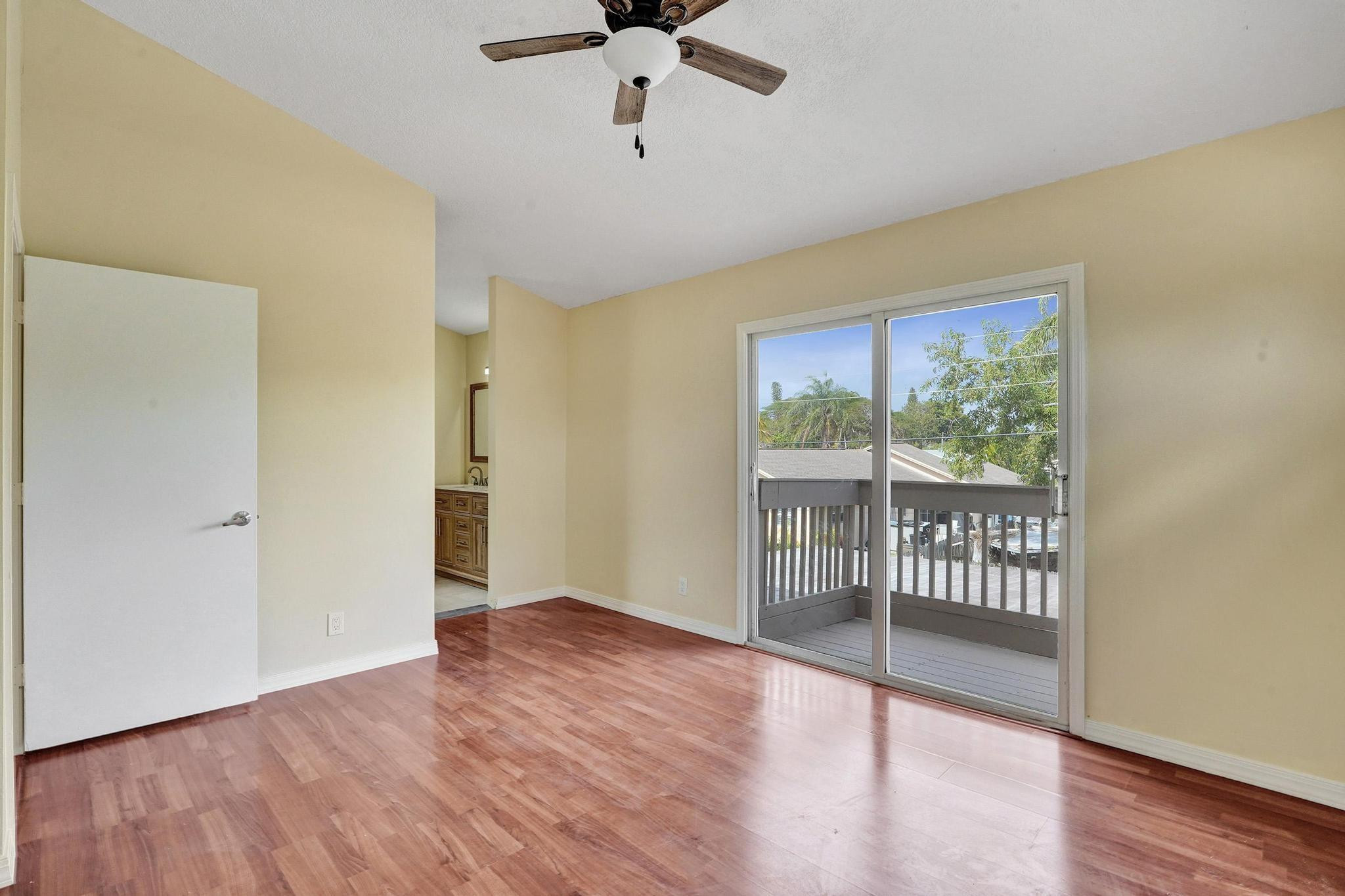 5425 Cleveland Road Delray Beach, FL 33484 - Photo 20 of 39 wooden floor in an empty room with a window