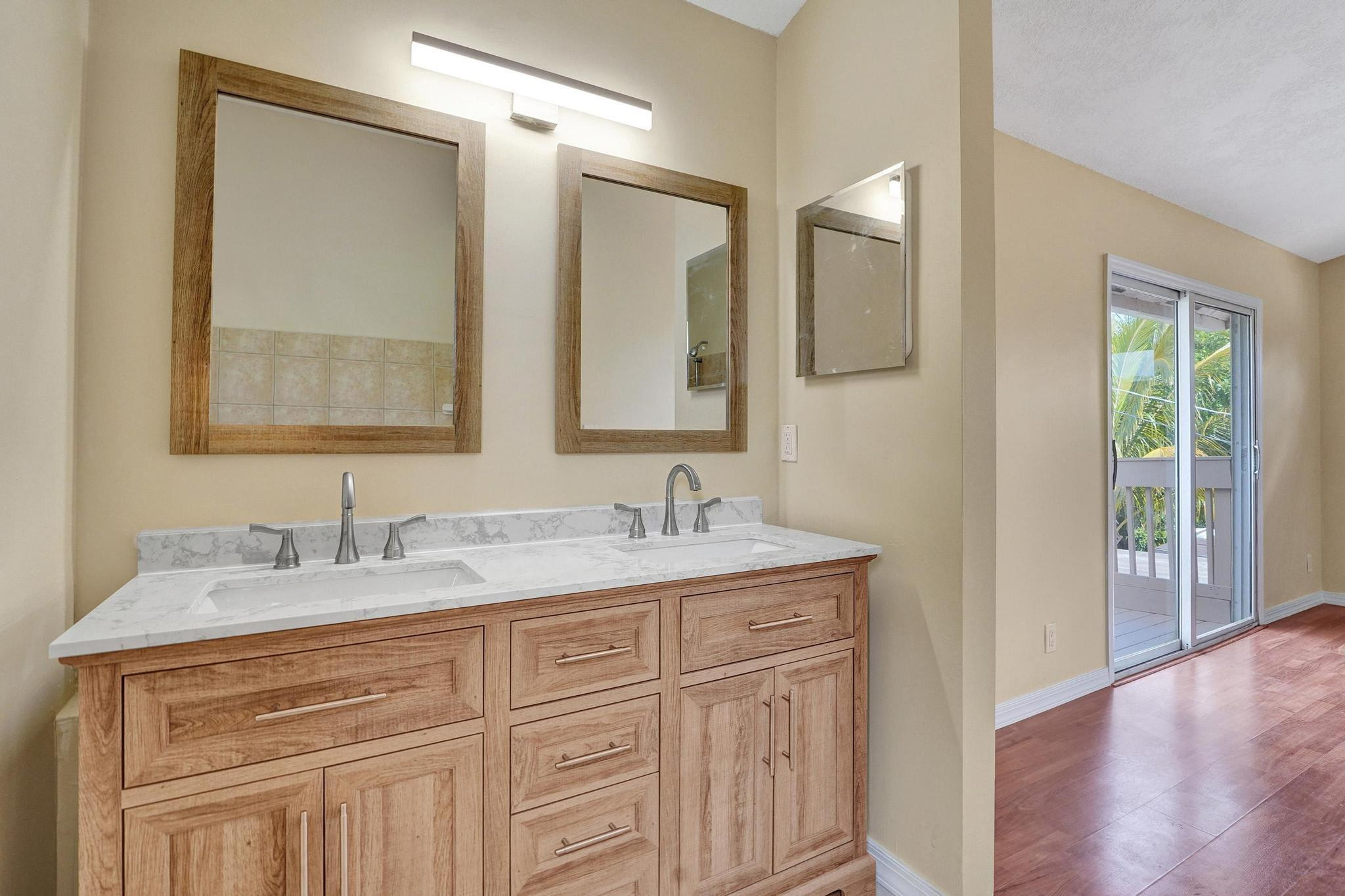 5425 Cleveland Road Delray Beach, FL 33484 - Photo 23 of 39 a bathroom with a sink and a mirror