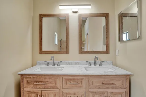 a bathroom with a granite countertop sink vanity and a mirror