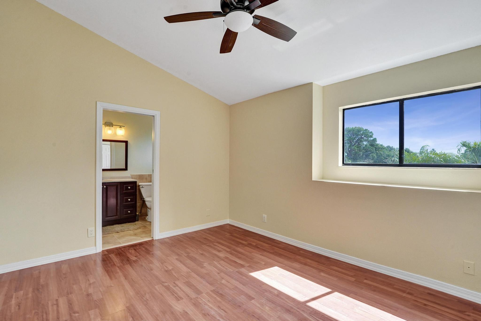 5425 Cleveland Road Delray Beach, FL 33484 - Photo 26 of 39 a view of an empty room with window and wooden floor