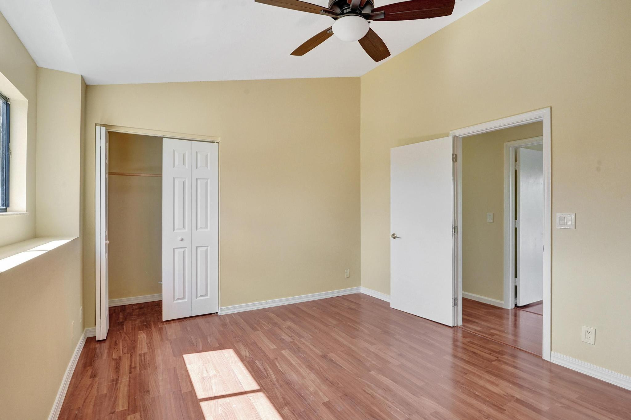 5425 Cleveland Road Delray Beach, FL 33484 - Photo 29 of 39 wooden floor in an empty room with a window