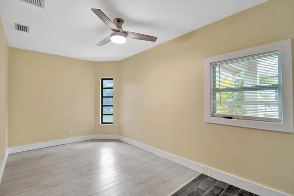 an empty room with windows and closet