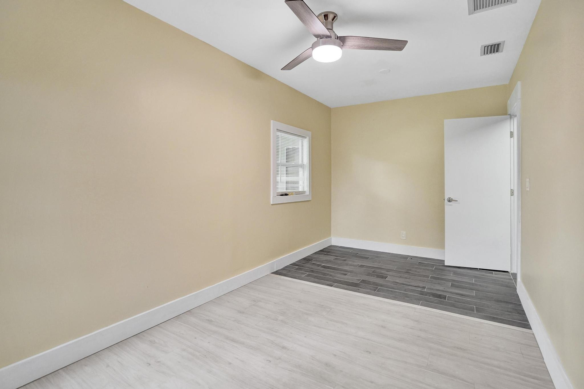 5425 Cleveland Road Delray Beach, FL 33484 - Photo 33 of 39 wooden floor in an empty room with a window
