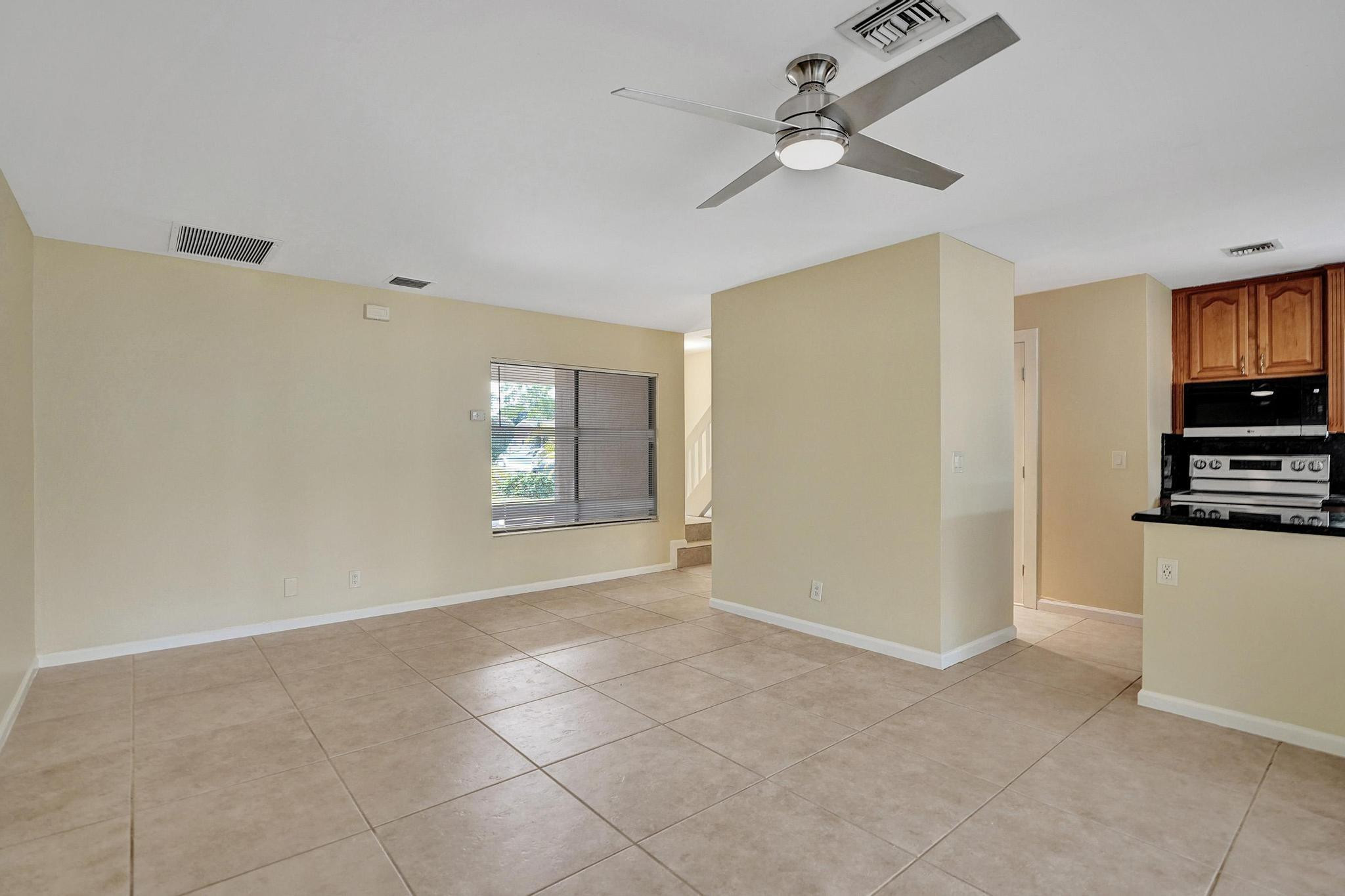 5425 Cleveland Road Delray Beach, FL 33484 - Photo 5 of 39 a view of an empty room with window and cabinet