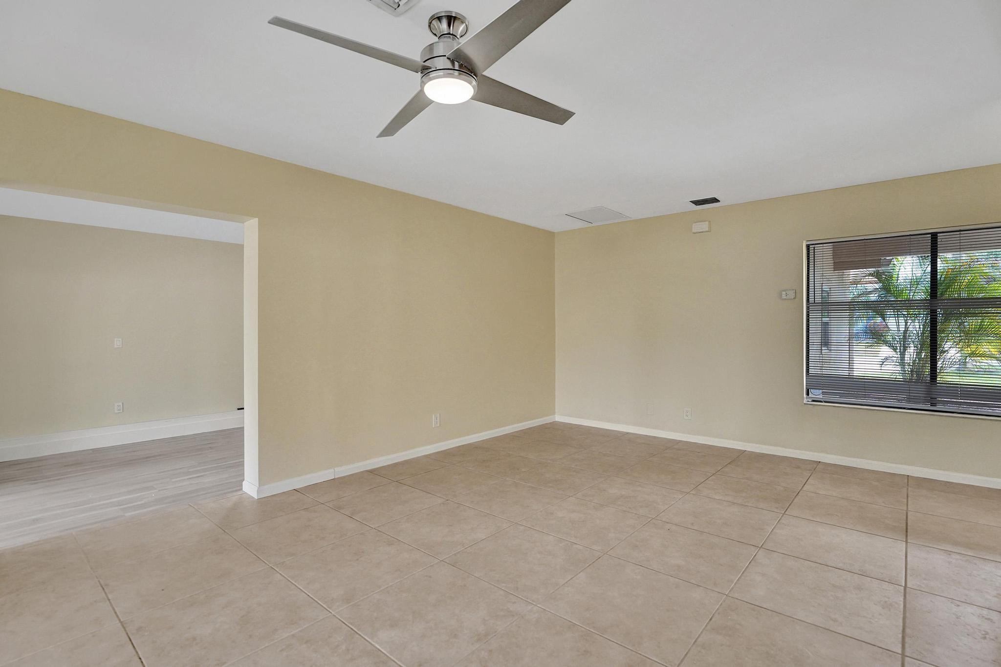 5425 Cleveland Road Delray Beach, FL 33484 - Photo 6 of 39 an empty room with windows and fan