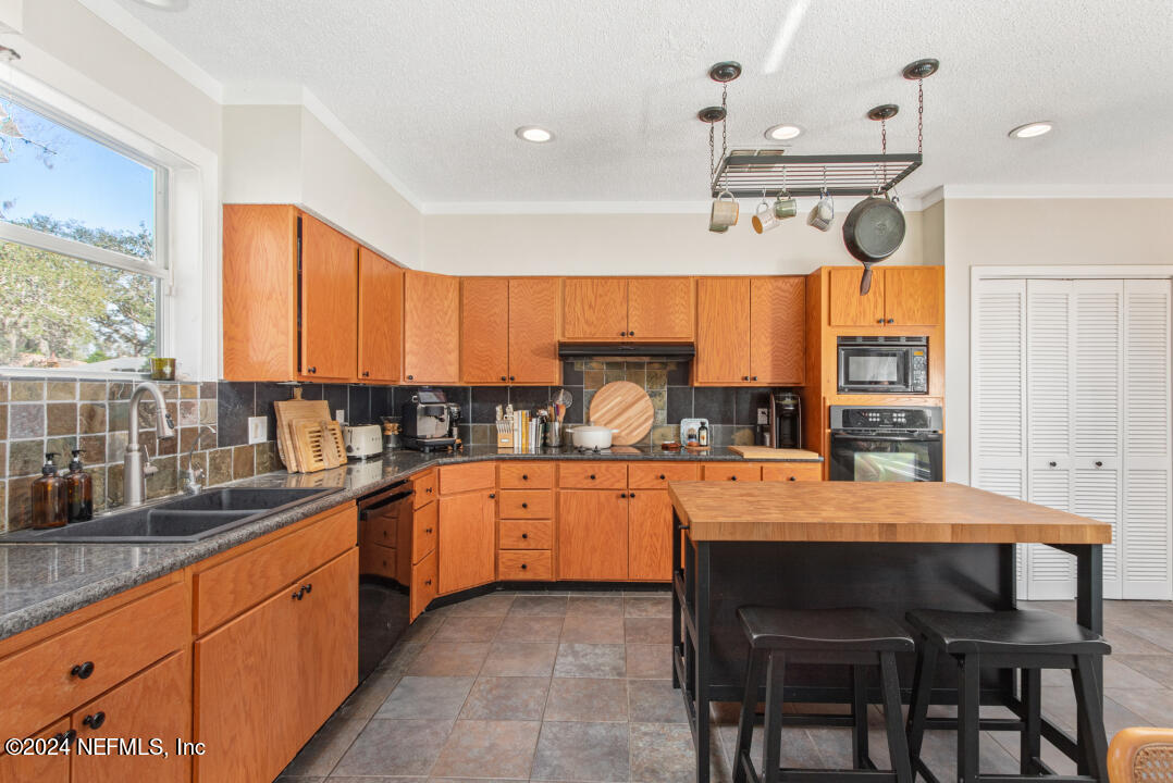 9644 Beauclerc Bluff Road Jacksonville, FL 32257 - Photo 15 of 48 a large kitchen with a table and chairs