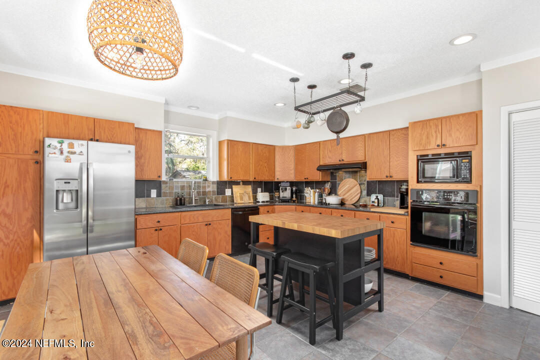 9644 Beauclerc Bluff Road Jacksonville, FL 32257 - Photo 16 of 48 a large kitchen with stainless steel appliances a stove a refrigerator a oven and a sink with cabinets