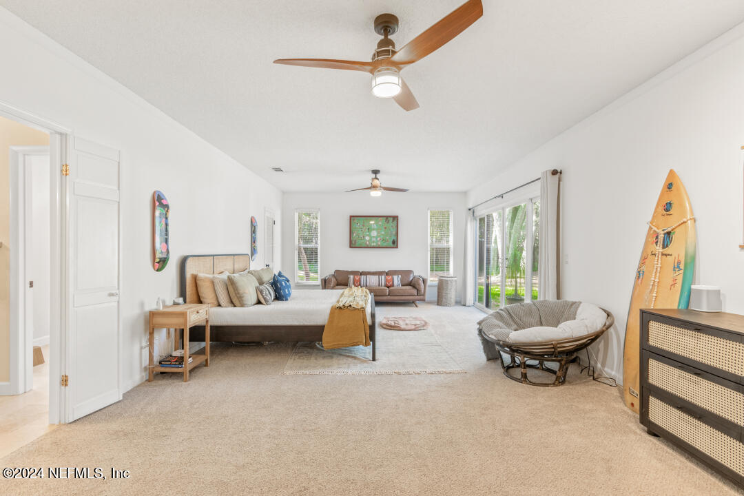 9644 Beauclerc Bluff Road Jacksonville, FL 32257 - Photo 19 of 48 a living room with furniture and a large window