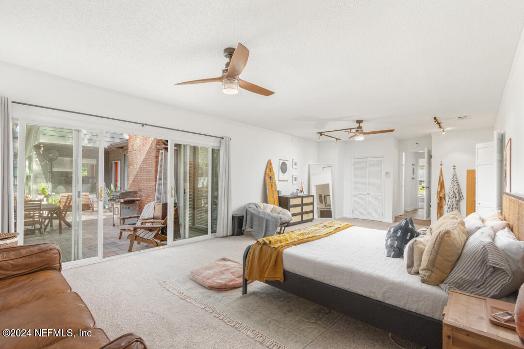 9644 Beauclerc Bluff Road Jacksonville, FL 32257 - Photo 21 of 48 a spacious bedroom with a bed and glass window