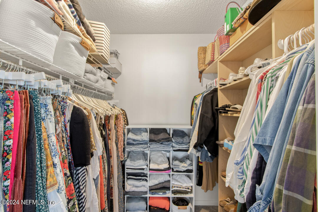 9644 Beauclerc Bluff Road Jacksonville, FL 32257 - Photo 25 of 48 a view of walk in closet with clothes and shoes