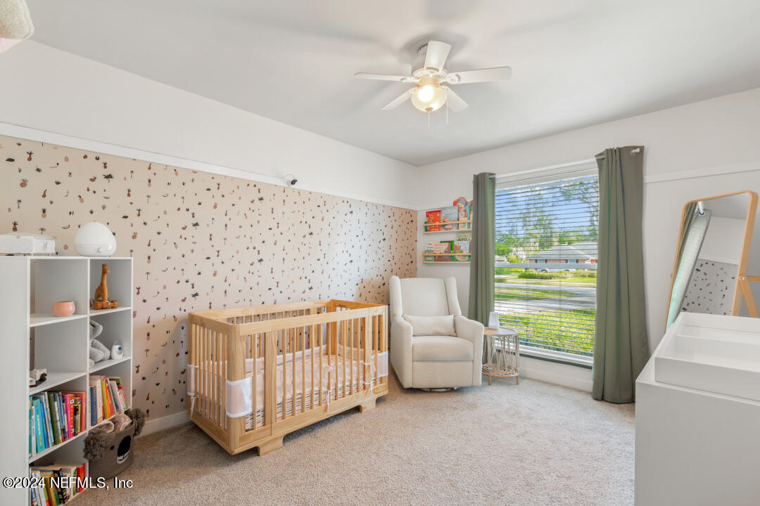 9644 Beauclerc Bluff Road Jacksonville, FL 32257 - Photo 27 of 48 a bedroom with furniture and a book shelf