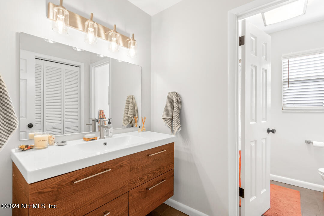 9644 Beauclerc Bluff Road Jacksonville, FL 32257 - Photo 29 of 48 a bathroom with a sink vanity and a mirror