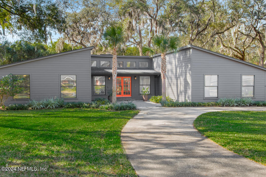 9644 Beauclerc Bluff Road Jacksonville, FL 32257 - Photo 3 of 48 a front view of a house with a garden