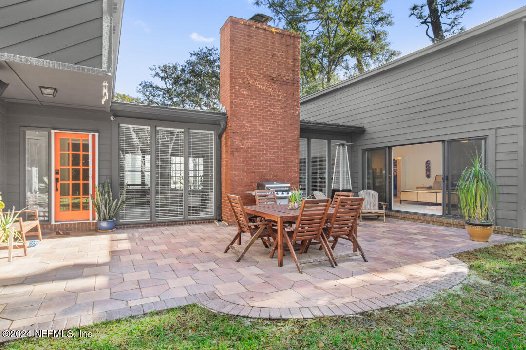 9644 Beauclerc Bluff Road Jacksonville, FL 32257 - Photo 32 of 48 a patio with table and chairs and potted plants