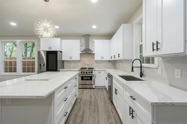 a kitchen with a sink stove and refrigerator