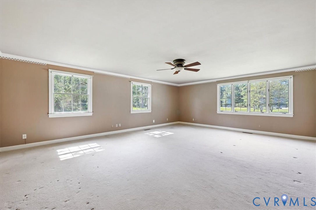 11701 Johnson Road Petersburg, VA 23805 - Photo 14 of 37 an empty room with windows and ceiling fan view