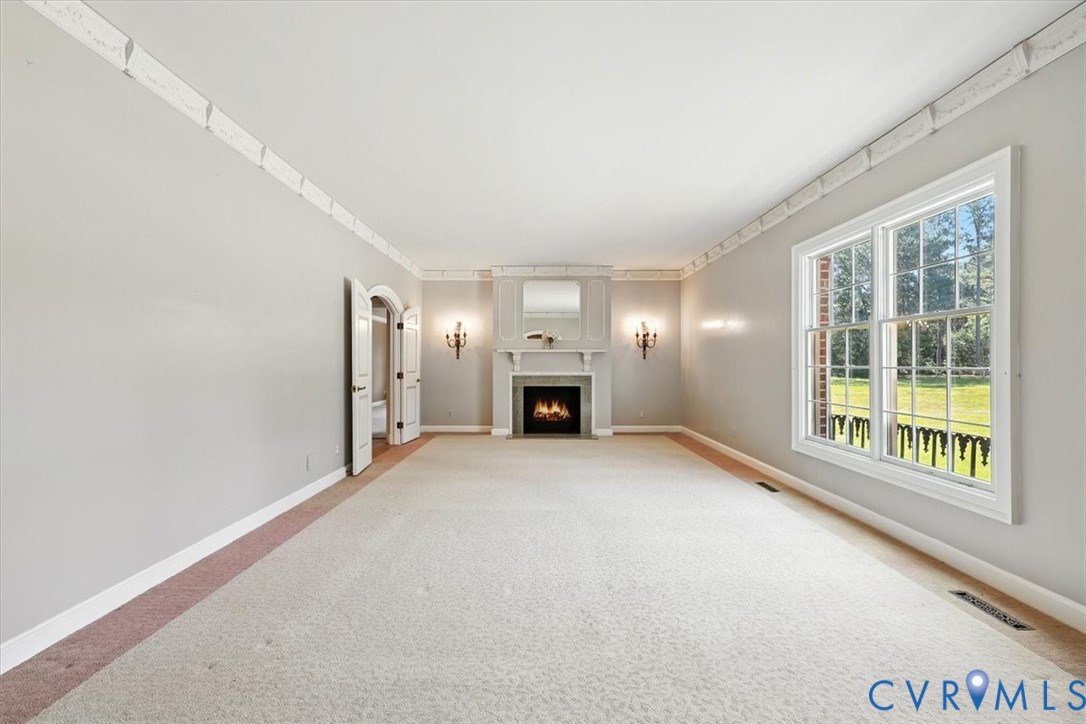 11701 Johnson Road Petersburg, VA 23805 - Photo 19 of 37 a view of an empty room with a fireplace and a window