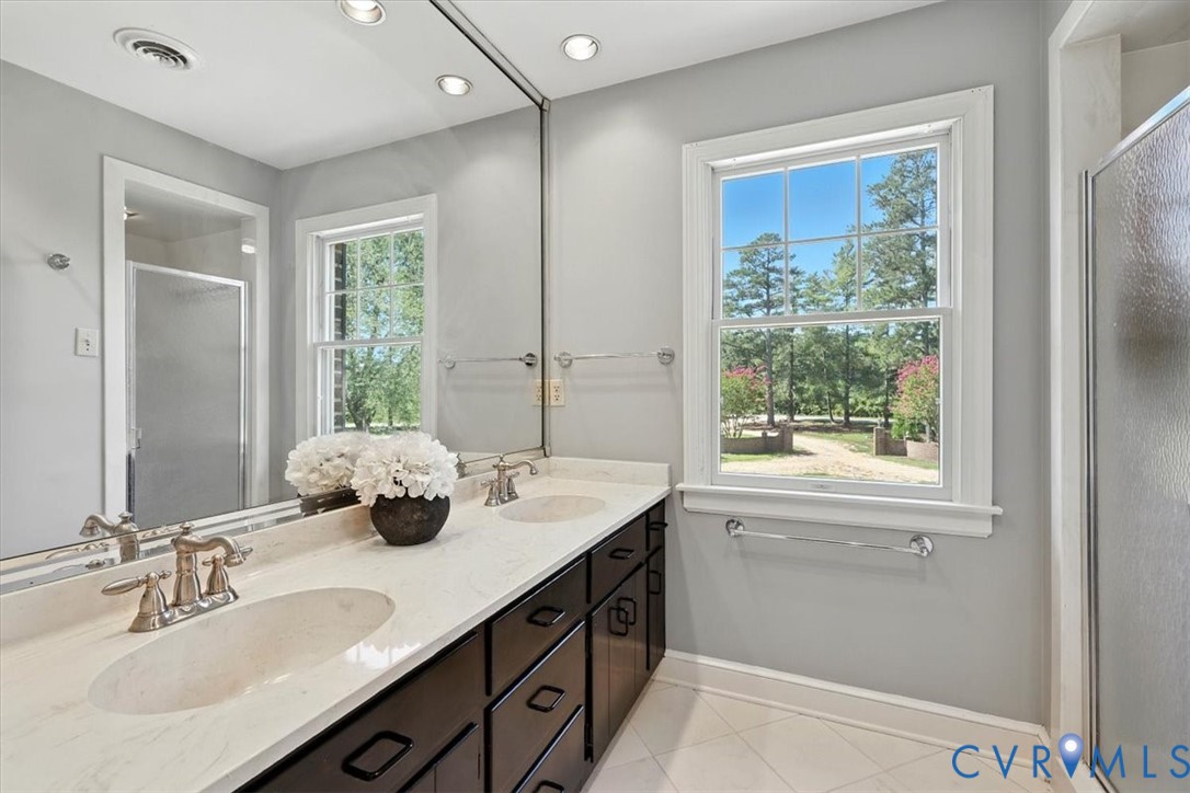 11701 Johnson Road Petersburg, VA 23805 - Photo 31 of 37 a bathroom with a sink double vanity and a mirror
