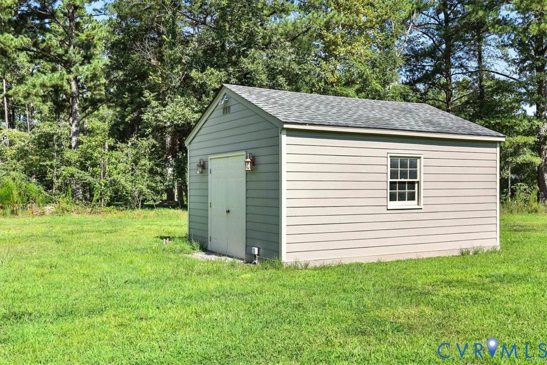 11701 Johnson Road Petersburg, VA 23805 - Photo 34 of 37 a view of a backyard with barn and large trees