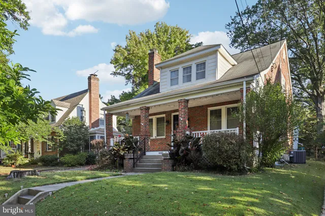 a view of a house with a yard and a garden