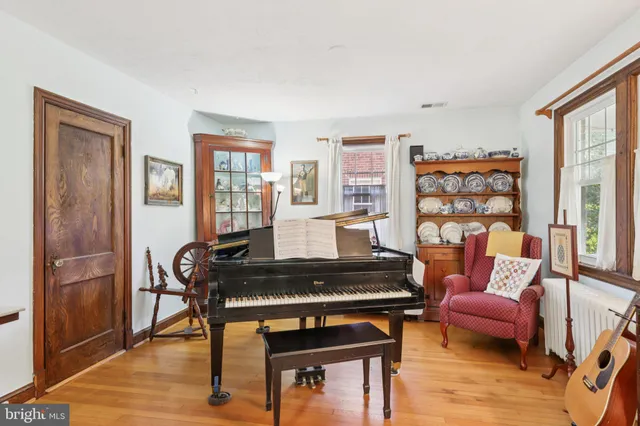 a living room with furniture and a piano