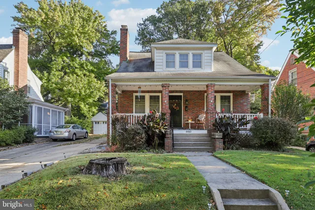 a front view of a house with garden and porch