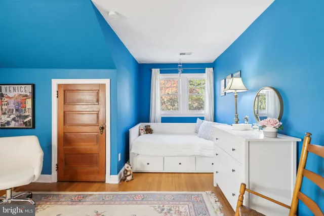 a bedroom with a bed dresser and a window