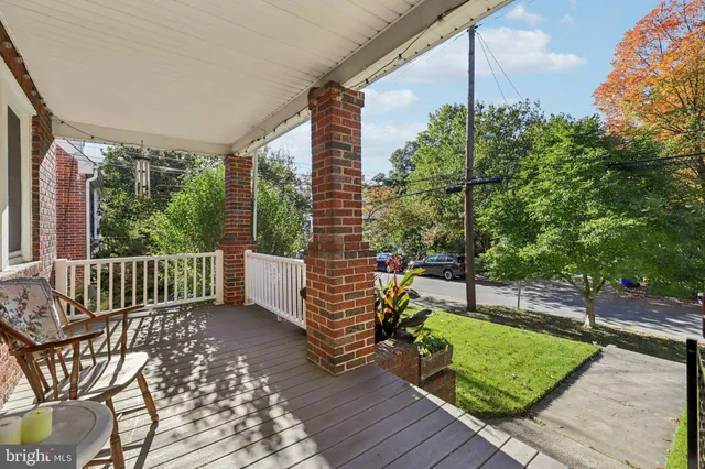 a view of a patio with a table and chairs and potted plants