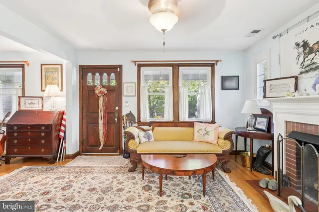 a living room with furniture a large window and a fireplace