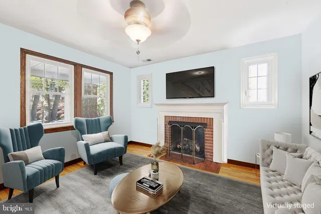 a living room with furniture a rug and a window