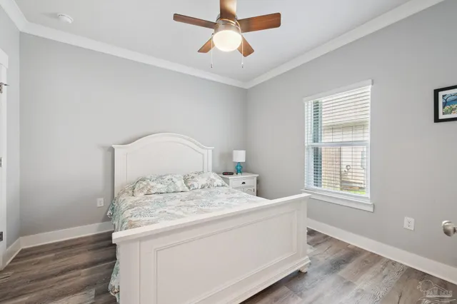 a bathroom with a granite countertop sink a toilet a mirror and shower