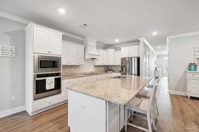 a kitchen with a sink and living room