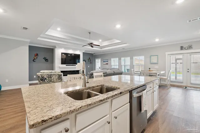 a kitchen with stainless steel appliances granite countertop a refrigerator and a stove