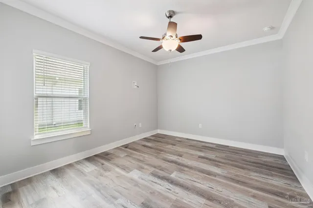 a dining room with furniture water view and a floor to ceiling window