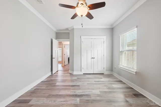 a view of pool with umbrella and wooden fence