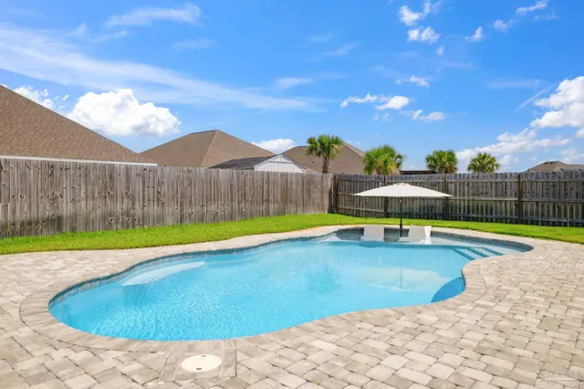 an aerial view of residential houses with outdoor space and parking