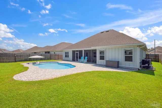aerial view of a house with pool and ocean view