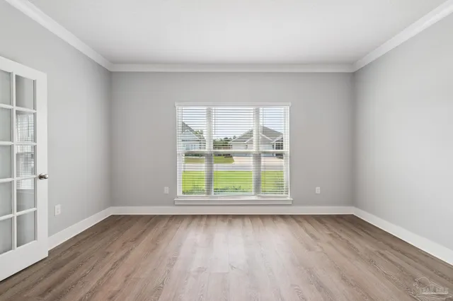 wooden floor in an empty room with a window