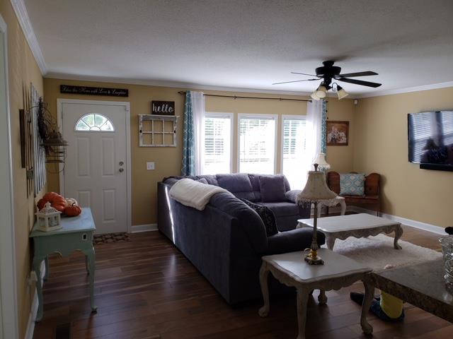 7381 Peaceful Acres Road Greenbrier, TN 37073 - Photo 4 of 15 a living room with furniture and a chandelier