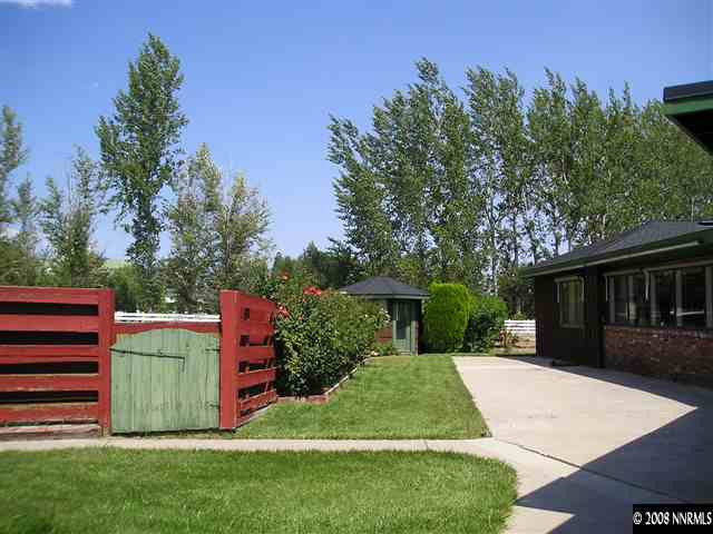 1175 Del Monte Lane Reno, NV 89511 - Photo 3 of 6 a front view of a house with a yard and a garden