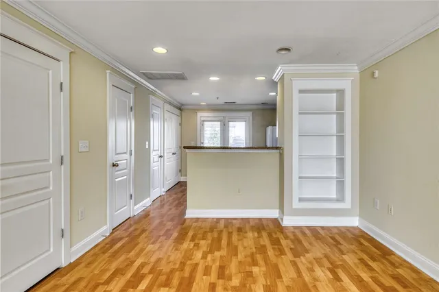a kitchen with refrigerator cabinets and wooden floor